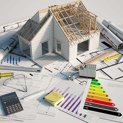 A new home under construction over architectural plans