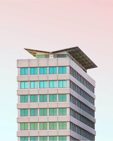 A modern residential building against a pale sky